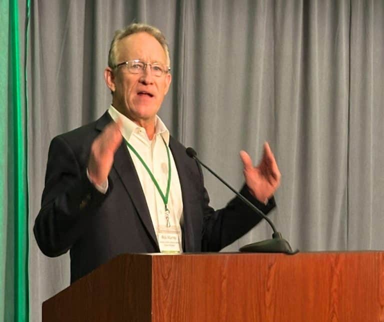Rick Murray speaking at a podium.