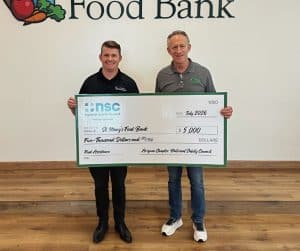 John Drake and Rick Murray holding big donation check